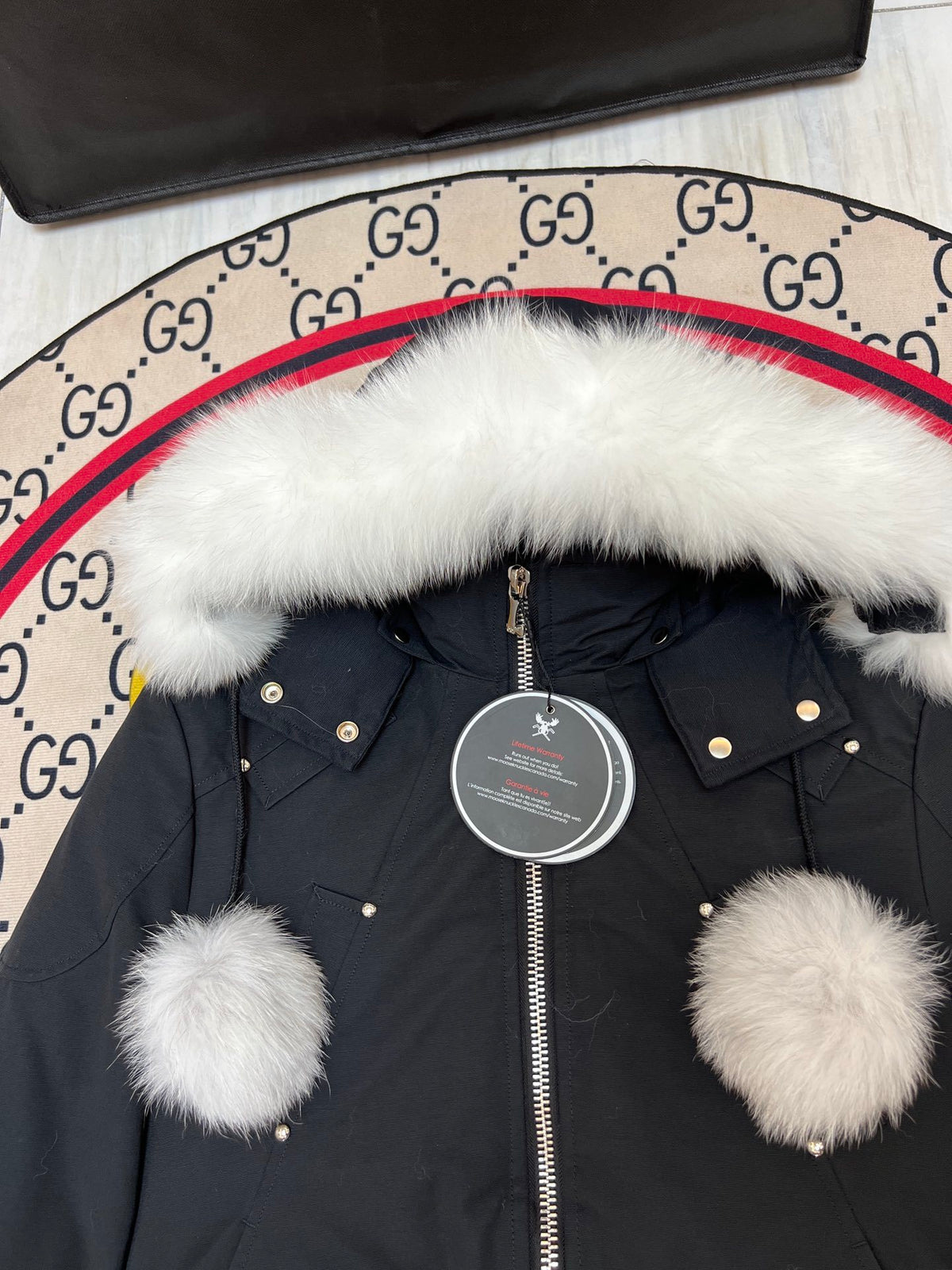 Moose Knuckles Black Down Parka with White Fur Hood and Pompom Zipper Pulls