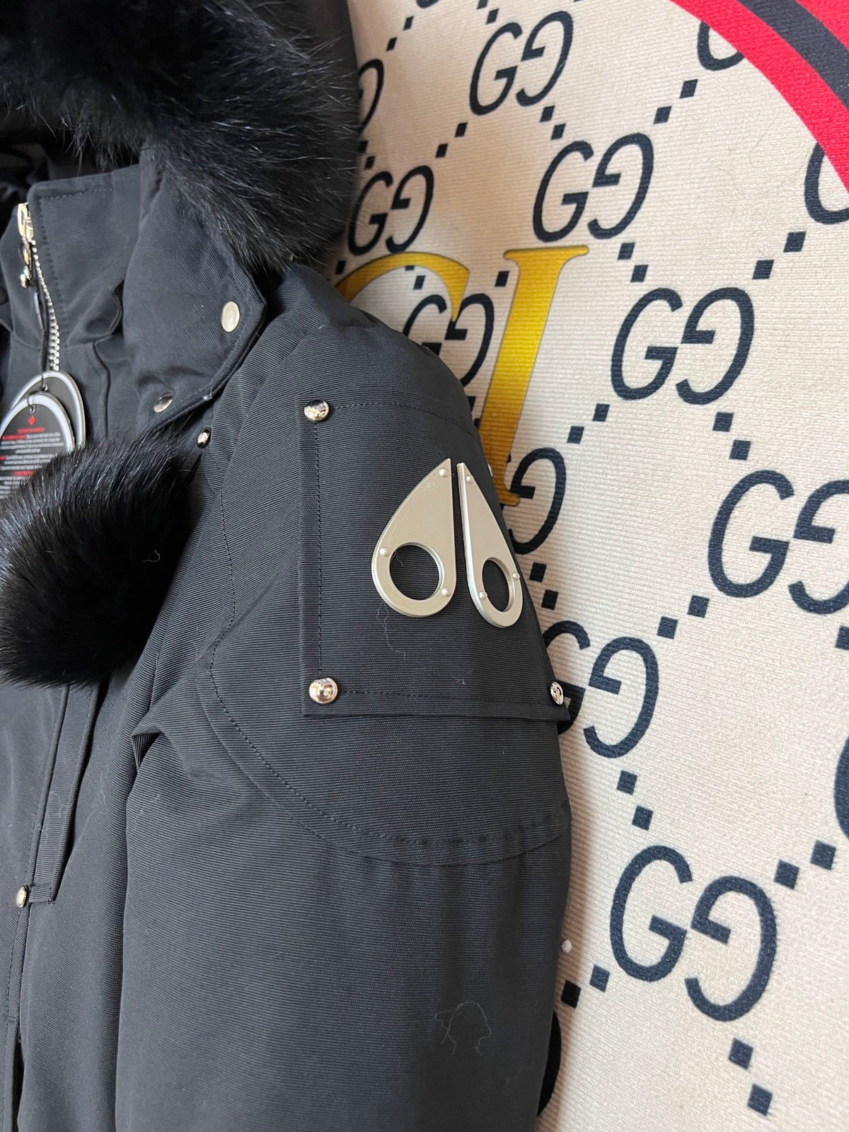 Moose Knuckles Black Down Parka with White Fur Hood and Pompom Zipper Pulls