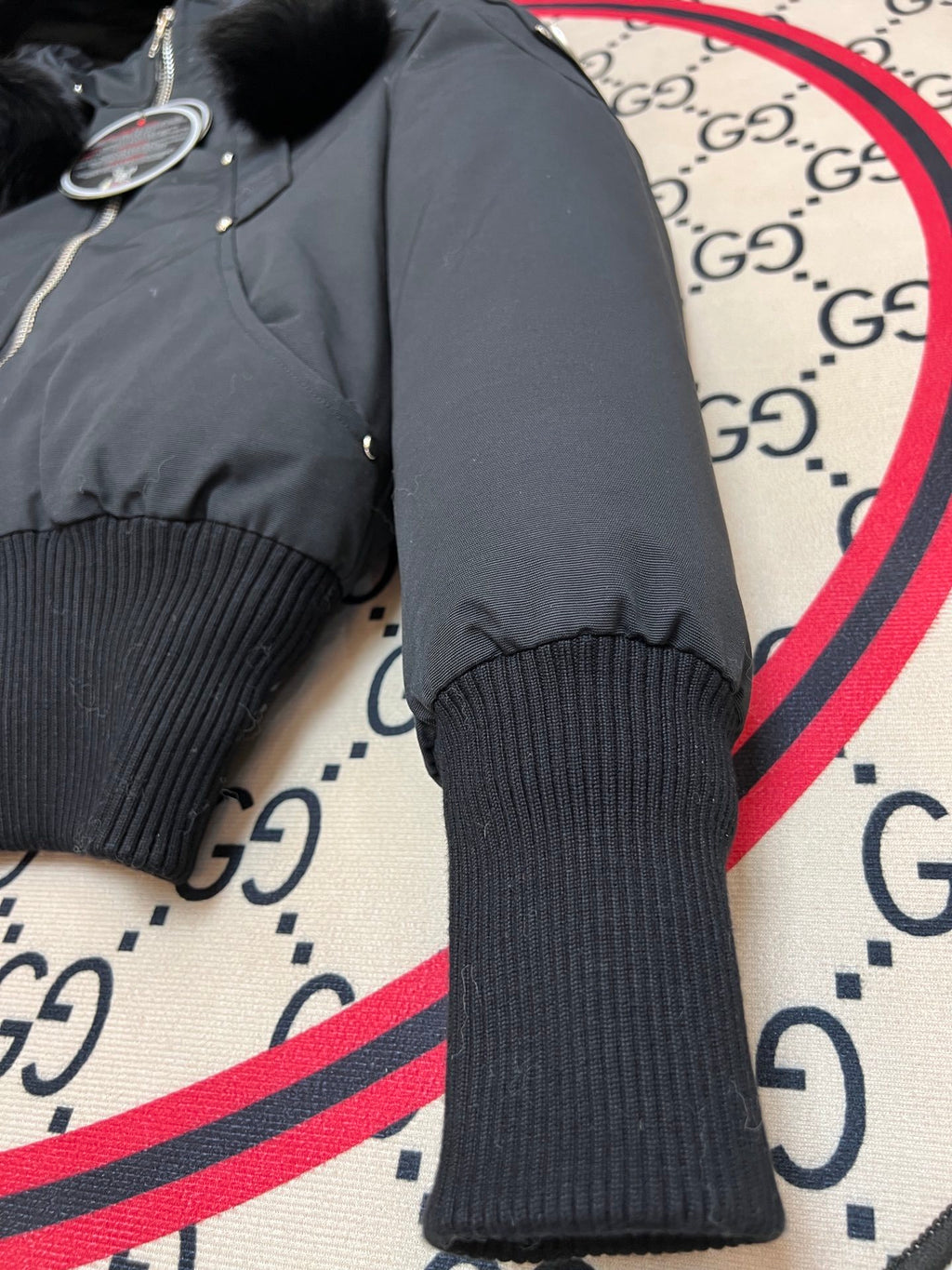 Moose Knuckles Black Down Parka with White Fur Hood and Pompom Zipper Pulls