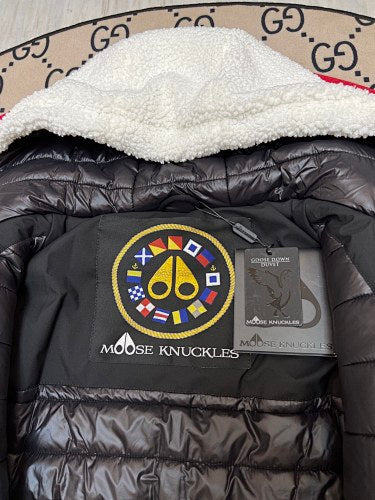 Moose Knuckles Black Down Puffer Jacket with White Sherpa Hood and Nautical Emblem Patch