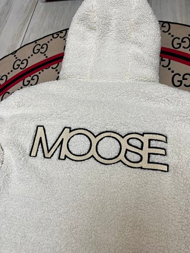 Moose Knuckles Black Down Puffer Jacket with White Sherpa Hood and Nautical Emblem Patch